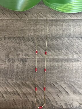 Delicate Gold Strand Necklace with Red Bead Accents